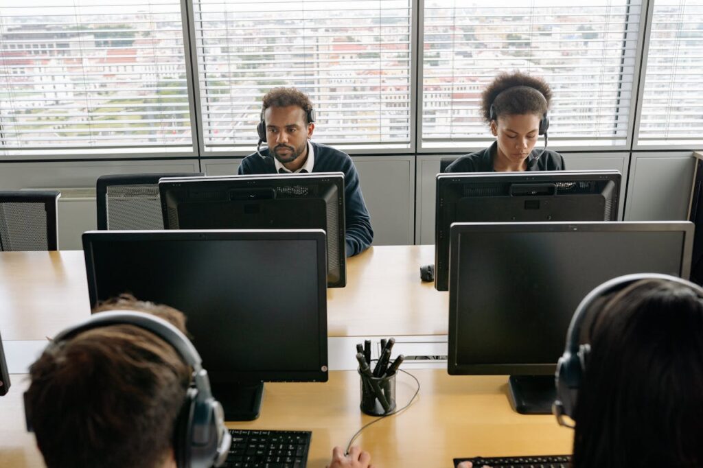 People Wearing Headsets Working in an Office