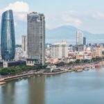Stunning aerial view of Da Nang skyline with skyscrapers by the river. Perfect for travel and urban stock photos.